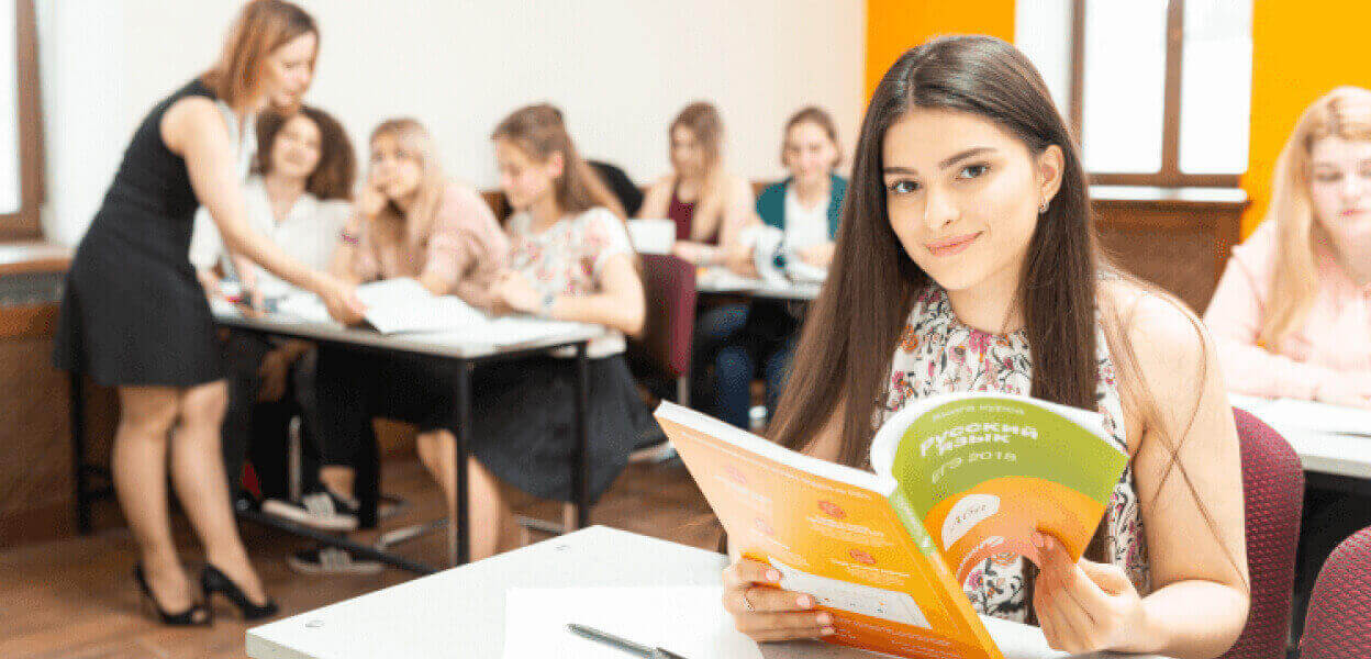 Девушка в классе подготовки по русскому языку.